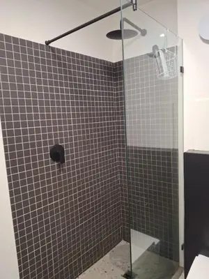 a bathroom with a shower with a glass door at Splendour on Dorp in Stellenbosch