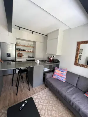 a living room with a couch and a kitchen at Splendour on Dorp in Stellenbosch