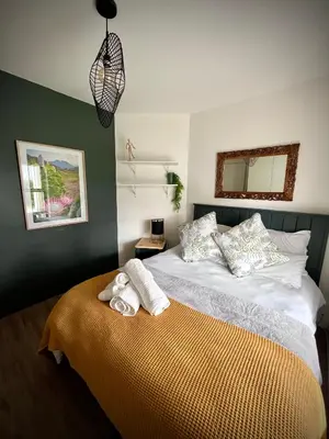 a bedroom with a bed with towels on it at Splendour on Dorp in Stellenbosch