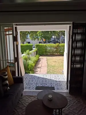 a living room with an open door to a yard at Splendour on Dorp in Stellenbosch