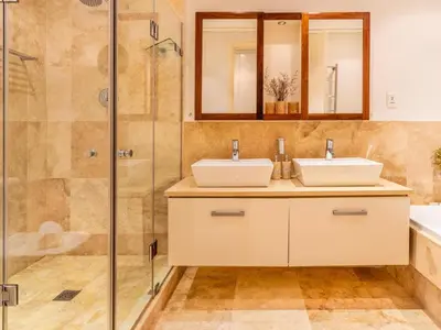 a bathroom with two sinks and a shower at 74 on Marine in Hermanus