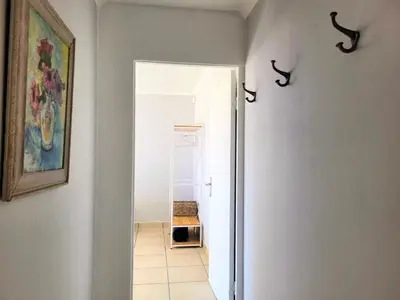 a hallway with an open door to a room at Silvertree Collective Ocean and Mountain View in Bettyʼs Bay
