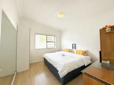 a bedroom with a bed and a window at Cheap Affordable Self-Catering Double Room with Pool, WiFi and Braai in Cape Town