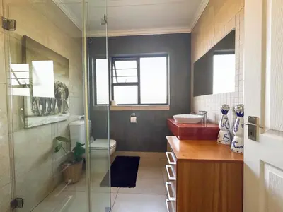 a bathroom with a toilet and a glass shower at Cheap Affordable Self-Catering Double Room with Pool, WiFi and Braai in Cape Town