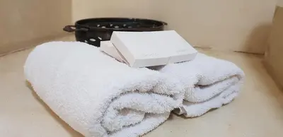 a box sitting on top of a white towel at Simondium's Country Lodge in Simondium