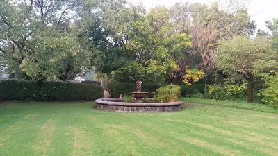 a garden with a fountain in the middle of a yard at Simondium's Country Lodge in Simondium