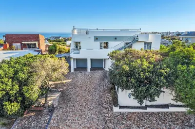 an aerial view of a white house with trees at Vermont Dreamcatcher in Hermanus