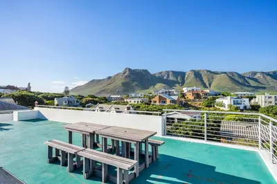a view from the roof of a house with two benches at Vermont Dreamcatcher in Hermanus