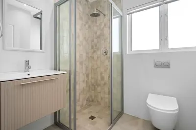 a bathroom with a shower and a toilet and a sink at Metalasia Four in Bettyʼs Bay