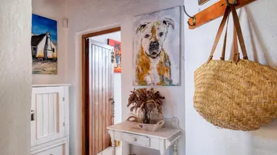 a hallway with a painting of a dog on the wall at Klein-Hangklip Remote Mountain Studio Cottage in Rooiels