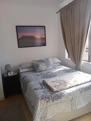 a bedroom with a bed and a window at Home in Bellville, Cape Town in Victory Hill