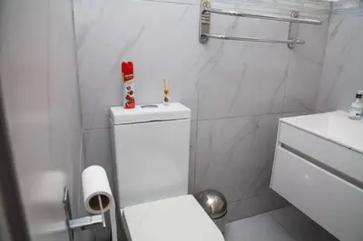 a white bathroom with a toilet and a sink at Fully Furnished Room and en-suite in Cape Town