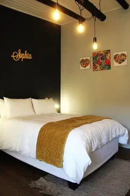 a bedroom with a large bed in a room at Lategansrus at Helpmekaar Farm in Wellington