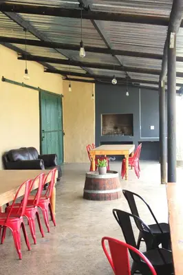 a conference room with red chairs and a table at Lategansrus at Helpmekaar Farm in Wellington