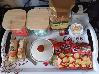 a table topped with food and a cup of coffee at Stylish Studio in Tableview Stay in Cape Town