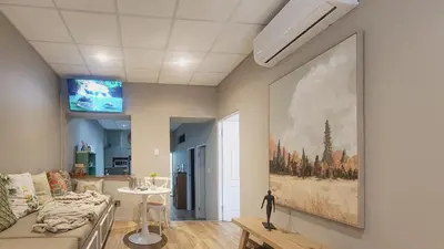 a living room with a large painting on the wall at The Botanic High Gold in Paarl