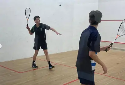 two men playing a game of tennis in a gym at Helderberg Hideaway Loft in Somerset West