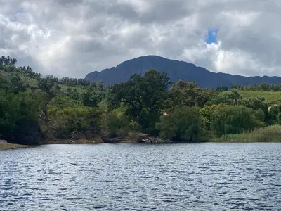 a large body of water with a mountain in the background at William's Cottage in Franschhoek