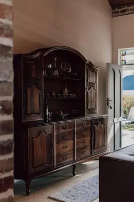 a large wooden entertainment center in a living room at The Crescent Hideaway in Franschhoek