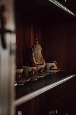 a tea kettle and two cups on a shelf at The Crescent Hideaway in Franschhoek