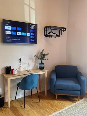 a room with a desk and a chair and a tv at Paarl Boutique Hotel in Paarl