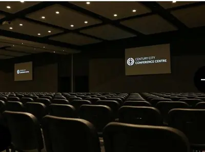 an empty auditorium with chairs in a room at Luxe at Nine Palms Near Canal Walk in Cape Town