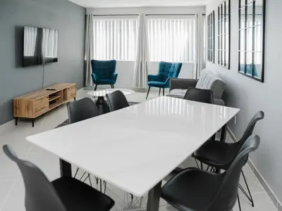 a meeting room with a white table and chairs at Romilly Beachfront 92 in Strand