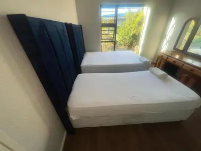 two beds in a small room with a window at triplediz in Blackheath