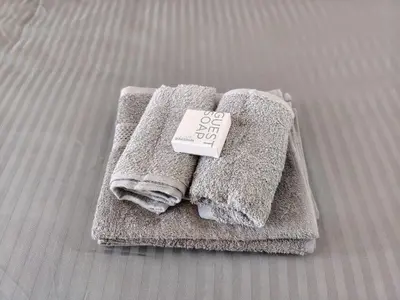 a pile of towels with a price sign on them at Kenwyn Micro Apartments 2 in Cape Town