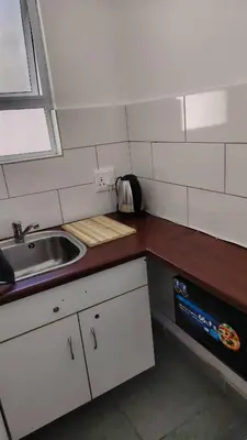 a small kitchen with a sink and a counter at Kenwyn Micro Apartments 2 in Cape Town
