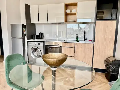 a kitchen with a glass table and a glass chair at Modern Luxe On Park in Cape Town