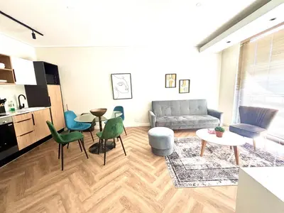 a living room with a couch and a table and chairs at Modern Luxe On Park in Cape Town