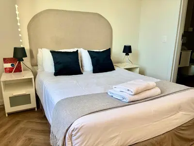 a bedroom with a large bed with towels on it at Modern Luxe On Park in Cape Town