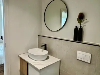 a bathroom with a sink and a mirror at Modern Luxe On Park in Cape Town