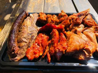 a tray of food with meat and other foods at Guided Tour of Belhar South Africa in Belhar