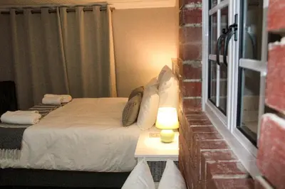 a small bedroom with a bed and a window at Firehouse selfcatering Garden Cottage no 2 in Wellington