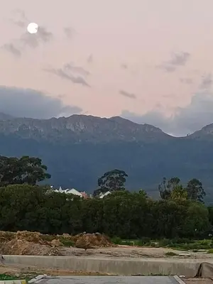 a view of mountains with the moon in the sky at Firehouse selfcatering Garden Cottage no 2 in Wellington