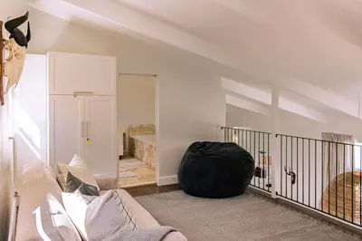 a living room with a large black ball sitting on the floor at Mimosa Voelklip Retreat in Hermanus