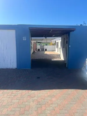 an empty garage with a blue wall and a parking lot at home away in Bellville South
