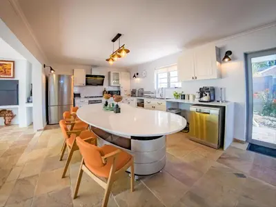 a kitchen with a large white table and chairs at Cape Joy - BRAND NEW luxury villa just rolled out in Cape Town, Plattekloof in Plattekloof