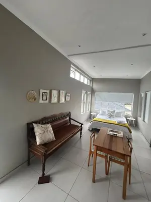 a bedroom with a bed and a table in it at 16Park in Stikland