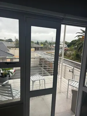 a glass door with a chair on a balcony at 16Park in Stikland