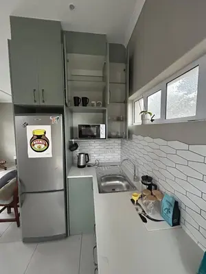 a kitchen with a refrigerator and a sink at 16Park in Stikland