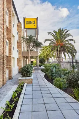a building with a sign that reads sun at SUN1 Parow Cape Town in Avondale
