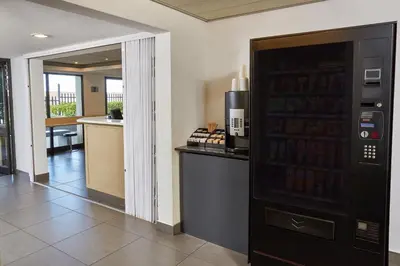 a room with a drink dispenser in a building at SUN1 Parow Cape Town in Avondale