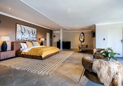 a bedroom with a bed and a living room at Von Wyn Berg in Stellenbosch