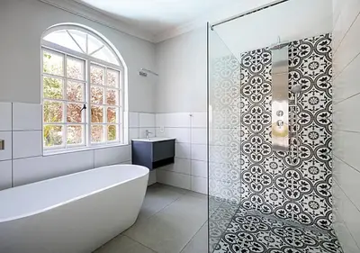 a white bathroom with a tub and a window at Von Wyn Berg in Stellenbosch