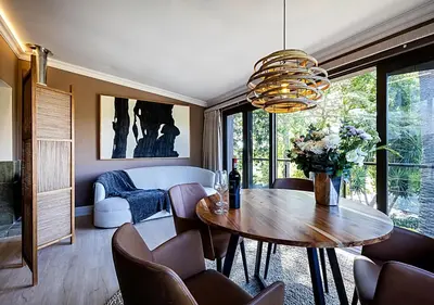 a living room with a table and chairs at Von Wyn Berg in Stellenbosch