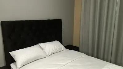a bed with a black headboard and white pillows at Spring forth guest house in De Grendel