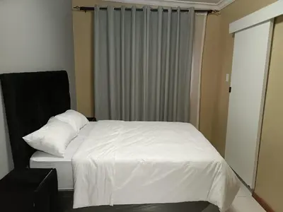 a bedroom with a white bed and a window at Spring forth guest house in De Grendel